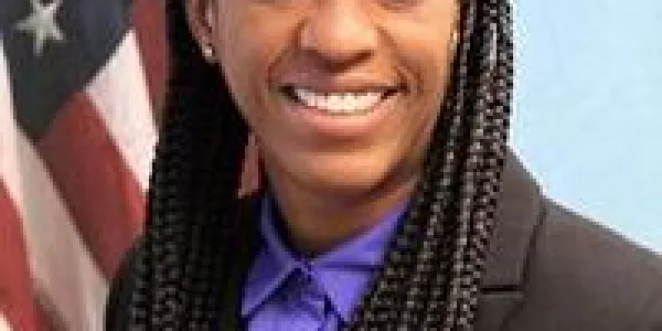 Portrait photo of Agent-In-Charge Dinah Foster in front of the American flag.