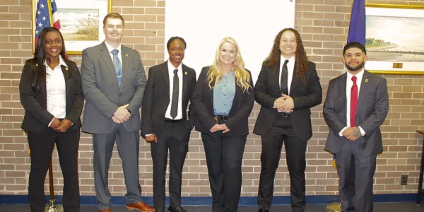 Group of six Probation, Parole and Pardon Services agents in business attire.