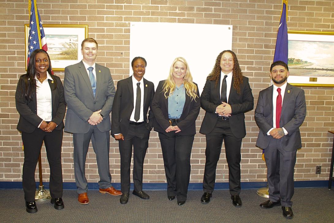 Group of six Probation, Parole and Pardon Services agents in business attire.